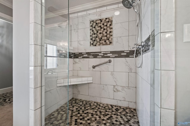 bathroom featuring a shower with shower door and ornamental molding