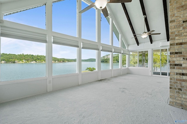 unfurnished sunroom with plenty of natural light, a water view, ceiling fan, and vaulted ceiling with beams