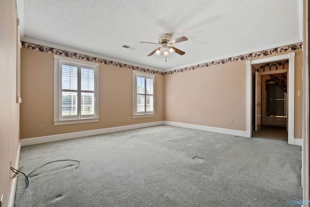 spare room with carpet floors, a textured ceiling, and ceiling fan