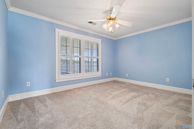 carpeted spare room with a textured ceiling, crown molding, and ceiling fan