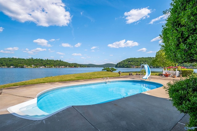 view of swimming pool featuring a patio and a water slide