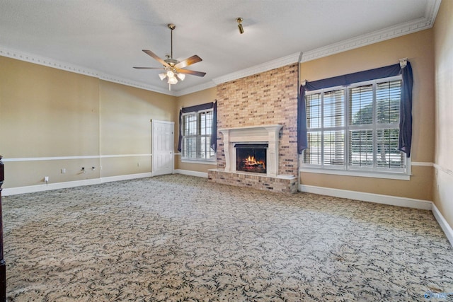 unfurnished living room with carpet floors, a fireplace, a textured ceiling, brick wall, and ceiling fan