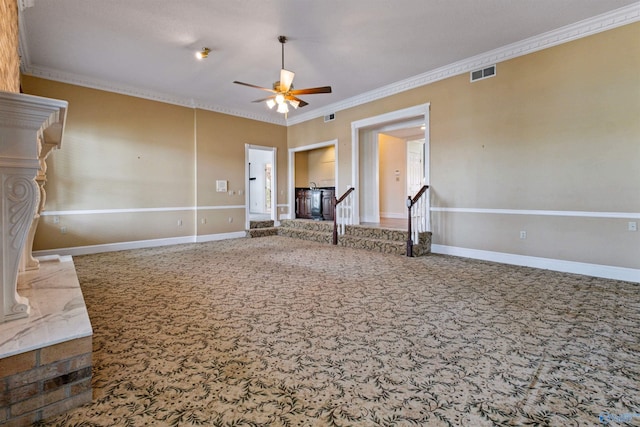 unfurnished living room featuring carpet, ceiling fan, and crown molding