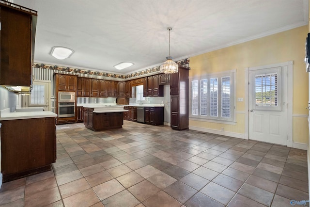 kitchen with light tile patterned flooring, dark brown cabinets, stainless steel appliances, ornamental molding, and a kitchen island