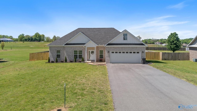 craftsman-style home featuring aphalt driveway, fence, a front lawn, roof with shingles, and brick siding
