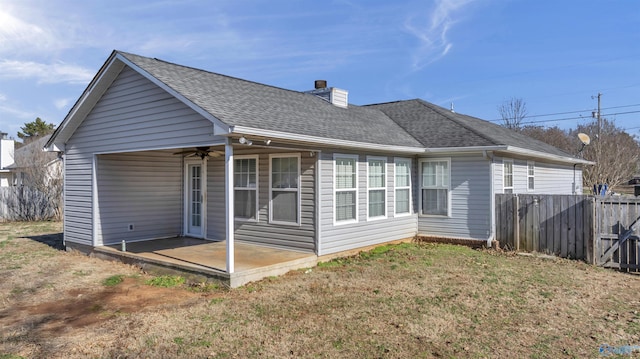 rear view of house with a yard, a patio, and ceiling fan