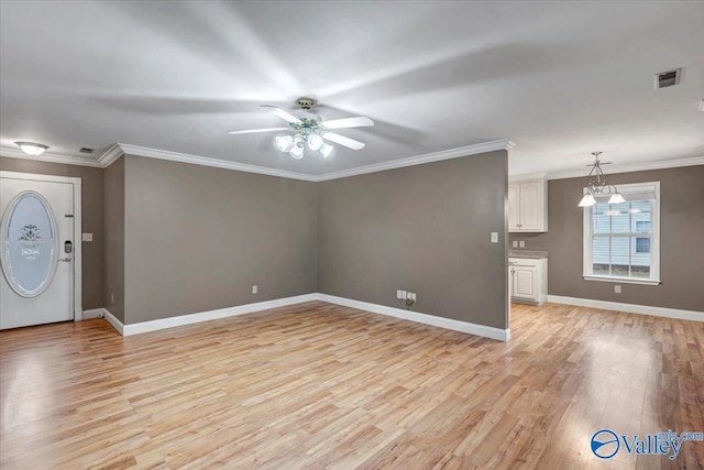 foyer with ceiling fan with notable chandelier, light hardwood / wood-style flooring, and crown molding