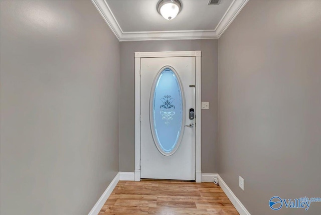 doorway to outside with crown molding and light wood-type flooring