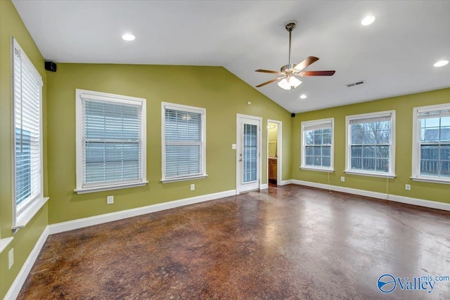 unfurnished room featuring ceiling fan, a healthy amount of sunlight, and vaulted ceiling