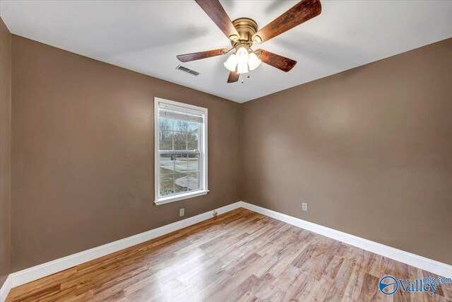 empty room featuring ceiling fan and light hardwood / wood-style flooring