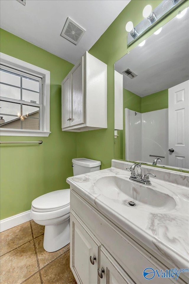 bathroom featuring a shower, vanity, and toilet