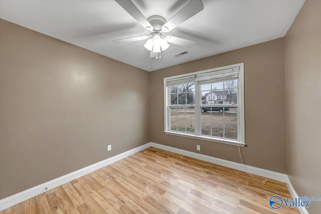 empty room with ceiling fan and light wood-type flooring