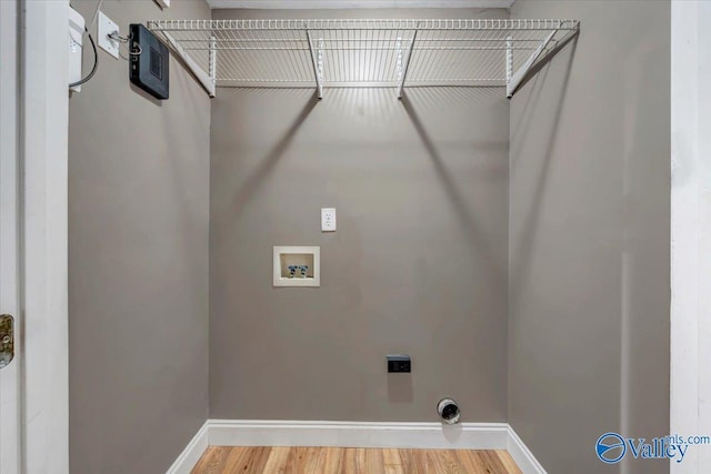 washroom featuring hookup for an electric dryer, hardwood / wood-style floors, and washer hookup