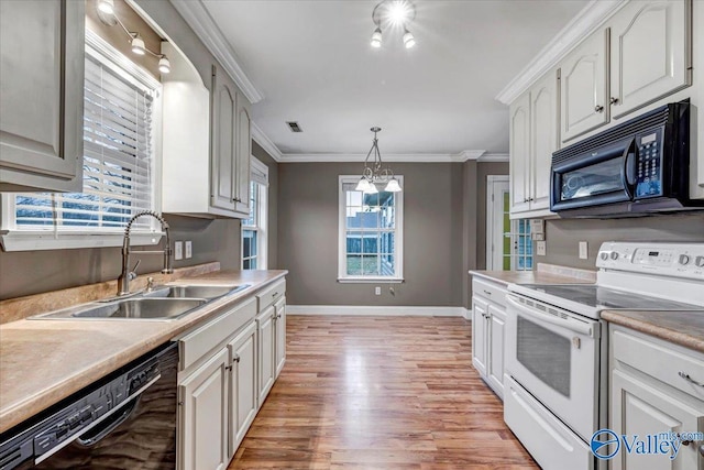 kitchen with black appliances, pendant lighting, ornamental molding, and sink