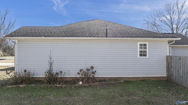 view of side of property with a lawn