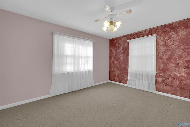 spare room with ceiling fan and carpet floors