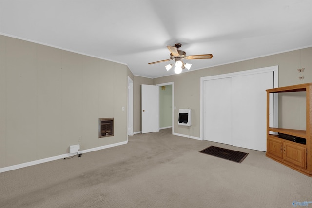 unfurnished living room featuring light colored carpet, ornamental molding, and heating unit