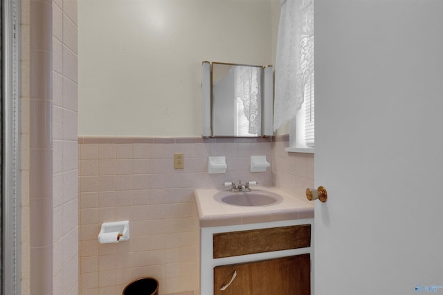 bathroom with vanity and tile walls