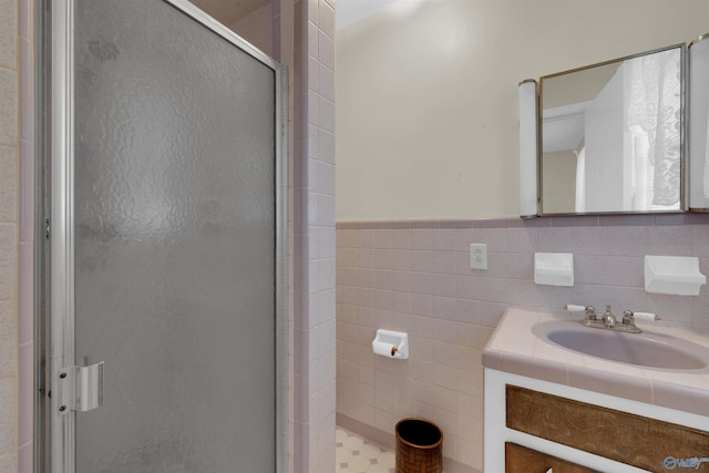 bathroom featuring vanity, tile walls, and walk in shower