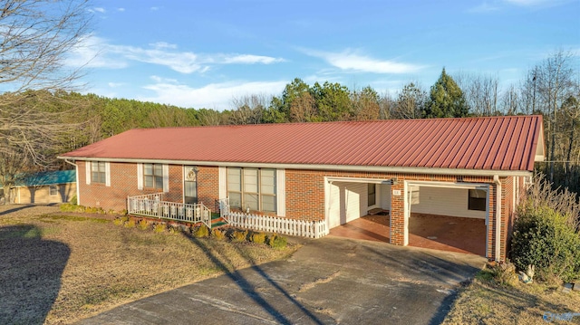 ranch-style home with covered porch and a carport