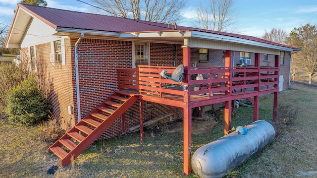 back of property with a lawn and a wooden deck