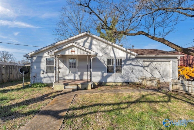 view of front facade featuring a front yard, fence, and an attached garage