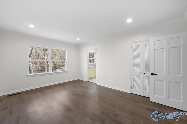 unfurnished room featuring dark hardwood / wood-style floors and crown molding