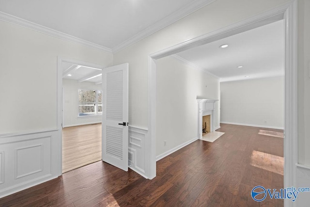 corridor with dark hardwood / wood-style floors and crown molding