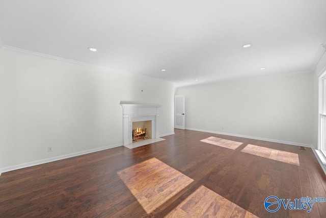 unfurnished living room with dark hardwood / wood-style flooring and ornamental molding