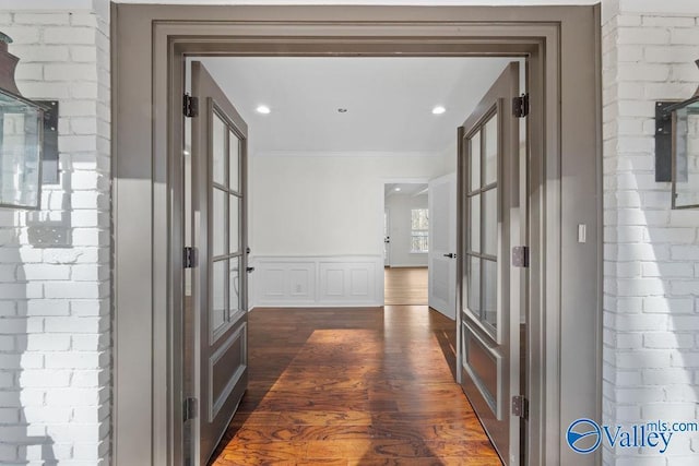 hallway featuring crown molding, french doors, and dark hardwood / wood-style floors