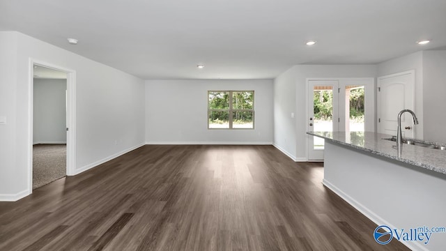 409 Jackson Point Cir, Huntsville, AL 35811 - unfurnished living room with a sink, baseboards, dark wood finished floors, and recessed lighting