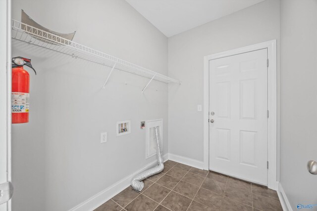 laundry area with washer hookup, electric dryer hookup, and dark tile patterned floors