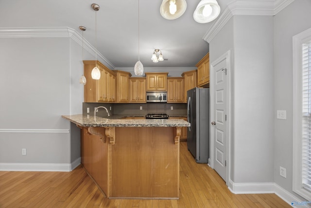 kitchen with light hardwood / wood-style floors, kitchen peninsula, crown molding, and appliances with stainless steel finishes