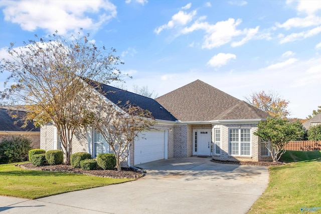 view of front of home with a garage and a front lawn