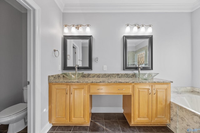 bathroom featuring vanity, toilet, ornamental molding, and tiled tub