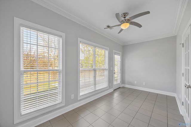 tiled empty room with ceiling fan and ornamental molding