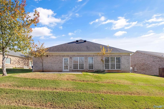 rear view of house featuring a lawn