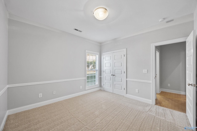 unfurnished bedroom with a closet and light hardwood / wood-style flooring