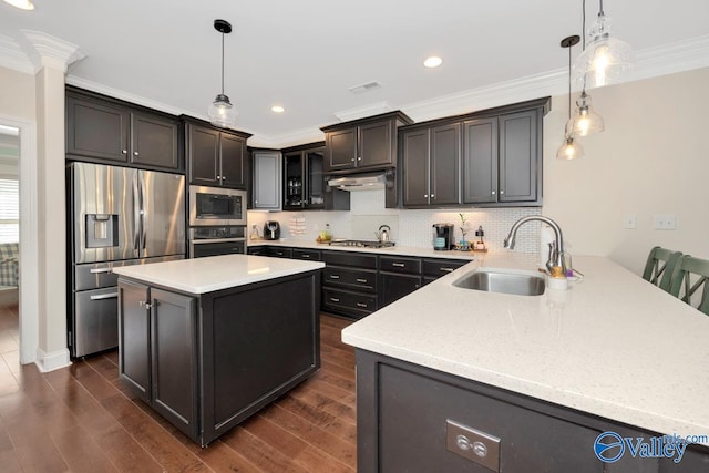 kitchen with kitchen peninsula, hanging light fixtures, stainless steel appliances, and sink