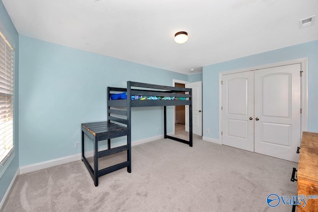 carpeted bedroom featuring a closet