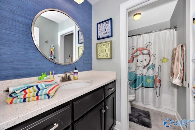 bathroom featuring tile patterned flooring, vanity, and toilet