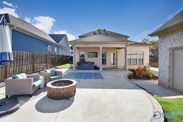 view of patio with an outdoor living space with a fire pit and a hot tub