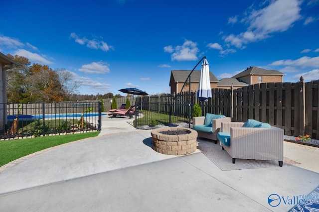 view of patio with a fire pit and a swimming pool