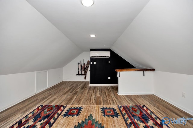 bonus room with hardwood / wood-style floors, vaulted ceiling, and a wall unit AC