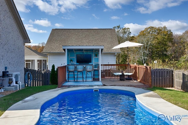 view of swimming pool with exterior bar and a patio