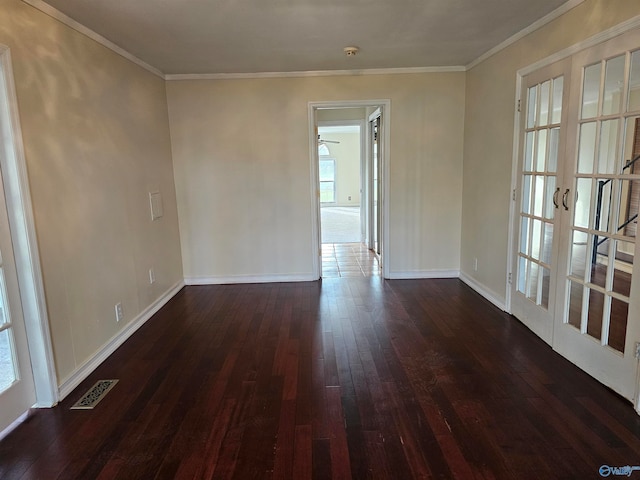 spare room featuring ceiling fan, crown molding, dark wood-type flooring, and french doors