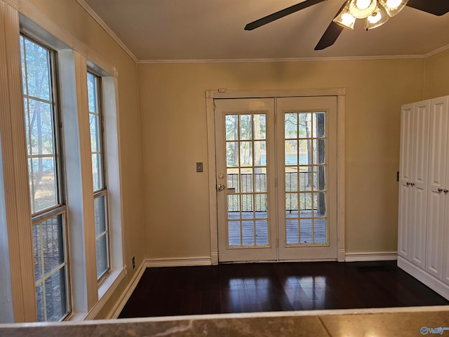 entryway featuring crown molding, ceiling fan, a healthy amount of sunlight, and dark hardwood / wood-style floors