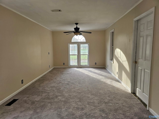 carpeted spare room featuring ceiling fan and ornamental molding