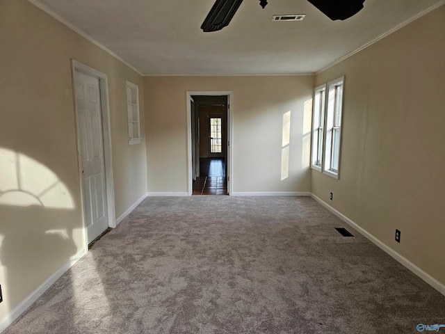 unfurnished room with carpet floors and crown molding