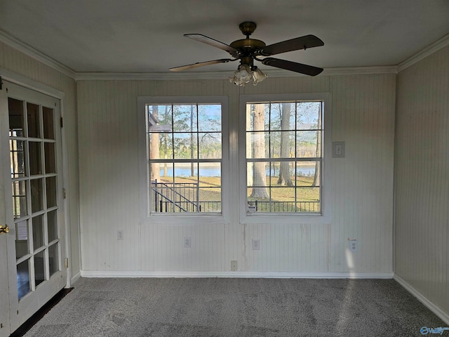 spare room featuring carpet flooring, ceiling fan, and crown molding